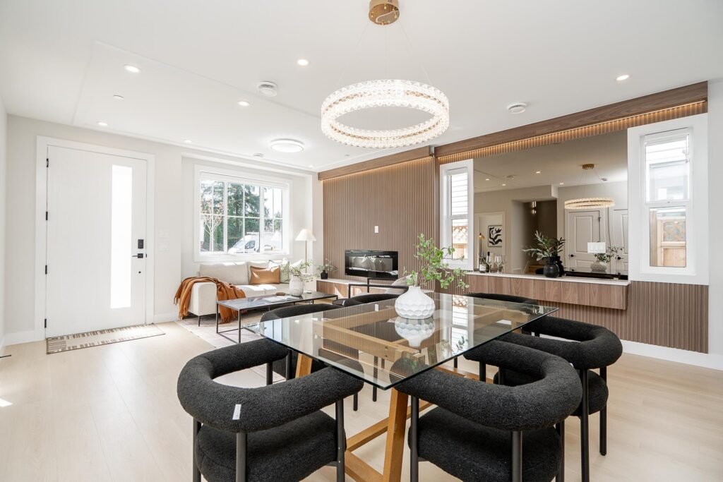 Brand-new half duplex at 101 – 1619 Manning Avenue, Port Coquitlam. Two-storey white and grey exterior with single garage, fenced front yard, and blue sky. Listed at $1,099,000. Sebastian Czarkowski, Royal LePage Elite West.